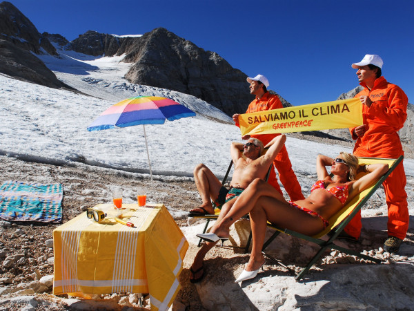 Marmolada (Italia). Una coppia prende il sole alla base del ghiacciaio per testimoniare gli effetti del surriscaldamento globale sui ghiacciai alpini. In 60 anni, il ghiacciaio della Marmolada si è ritirato di circa 650 metri.