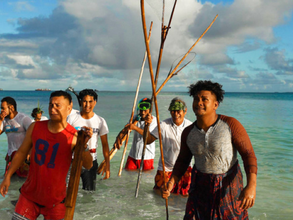 Locals during a traditional fishing practice to round up fish to be cooked on an umu (traditional earth oven) by the lagoon in Funafuti, Tuvalu, 15 August 2019. One of the first casualties of climate change and rising ocean temperatures is the decimation it causes to the fishery stocks. Many of the islanders rely on the fish stock for the basic subsistence and to feed their families. The 50th Pacific Islands Forum and Related Meetings, fostering cooperation between governments comprising 18 countries in the region, run from 13 to 16 August 2019 in Tuvalu.
