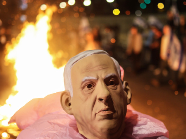 25 February 2023, Israel, Tel Aviv: A protester wears a mask of Prime Minister of Israel Benjamin Netanyahu during an anti-government protest