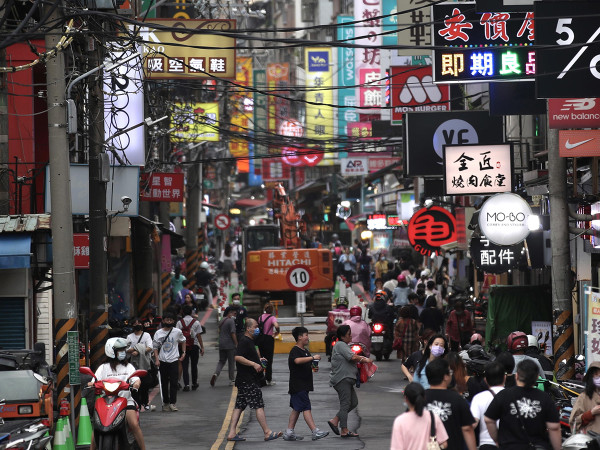People walk in the street in New Taipei city, Taiwan, 31 May 2023