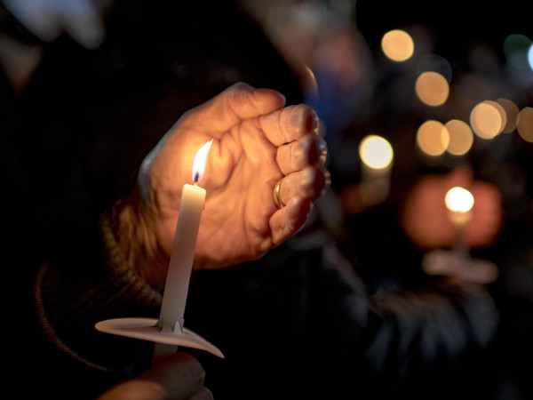 Community members participate in a vigil for the victims of Oxford High School shooting