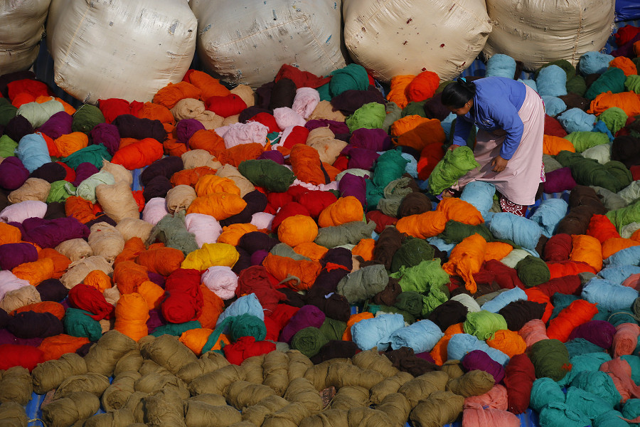Kathmandu (Nepal). Una donna nepalese asciuga il feltro di lana di pecora fatto a mano all&rsquo;interno della fabbrica Hatale, che impiega pi&ugrave; di 200 donne. Questo materiale naturale &egrave; considerato il primo tessuto nella storia dell’uomo. 
