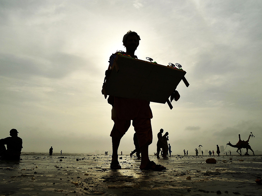 Karachi (Pakistan). Le persone si riuniscono in spiaggia dopo il passaggio del ciclone Biparjoy. Le autorit&agrave; pakistane hanno mantenuto un’allerta elevata nelle zone costiere