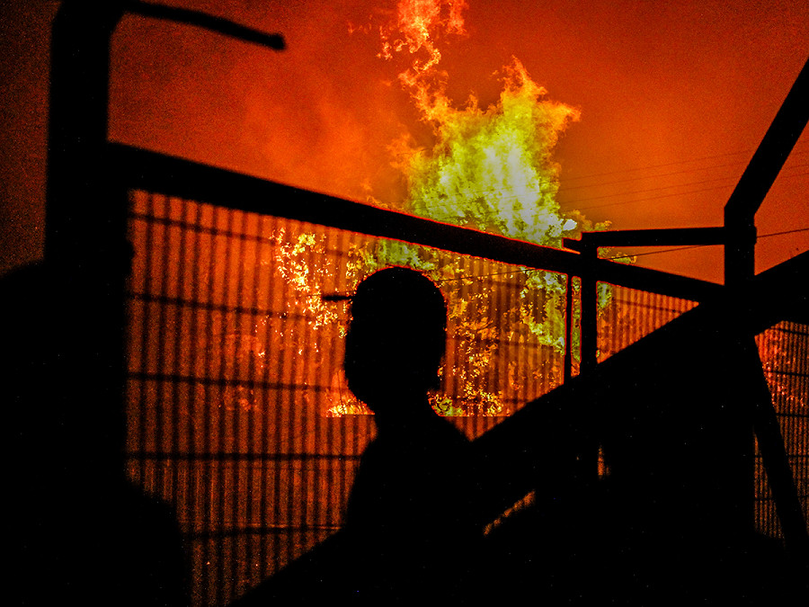 Vi&ntilde;a Del Mar (Cile). Un residente di Miraflores osserva le abitazioni in fiamme. Il bilancio del mega incendio divampato nella zona &egrave; di oltre 1.000 case bruciate, almeno 112 morti, centinaia di dispersi e 7.000 ettari carbonizzati. Il Paese ha dichiarato lo stato d&rsquo;emergenza.