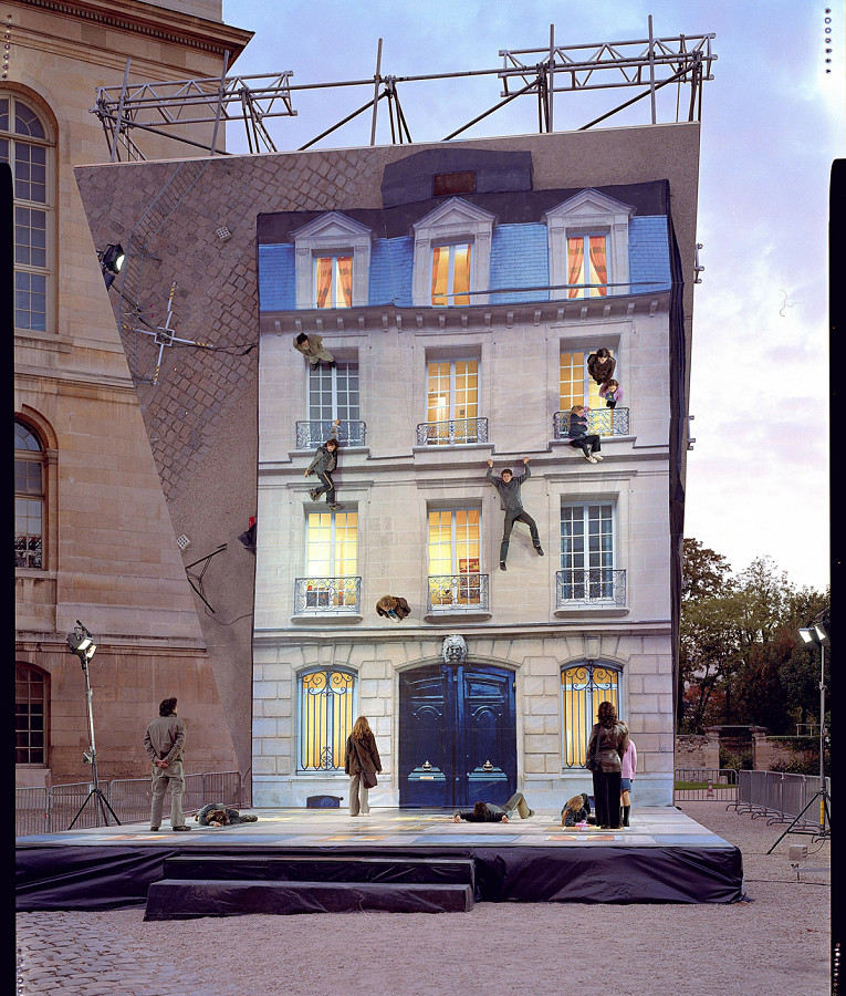 A building facade laid flat under a mirror suspended at a 45-degree angle Dimensions variable. Fourteen different facades each specific to the city that hosted the temporary installation