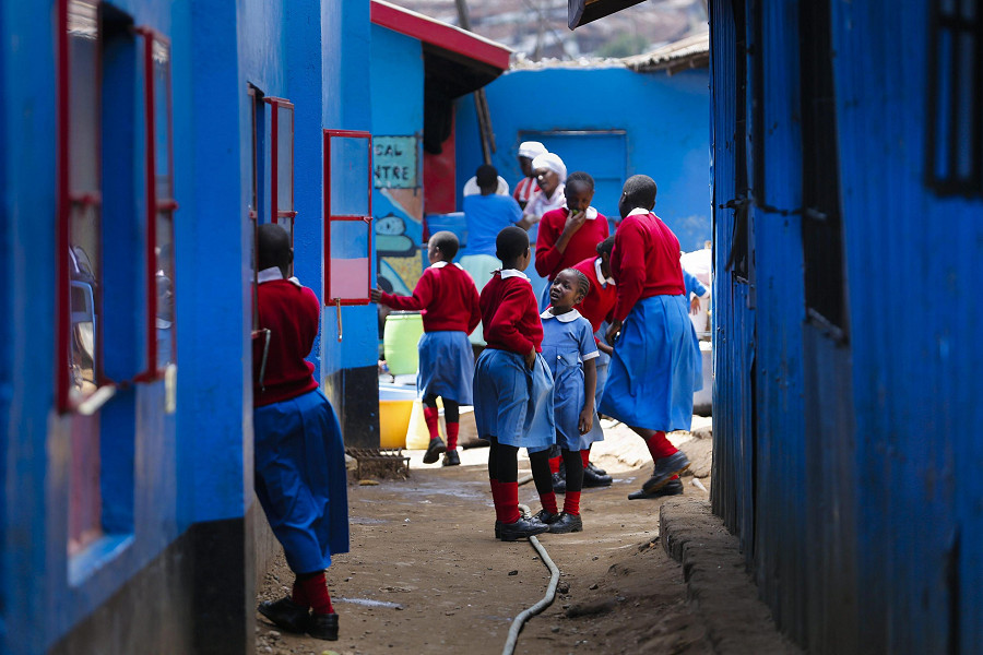 School girls play in front of their classroom in Kibera, the largest urban slum in Africa, in Nairobi, Kenya