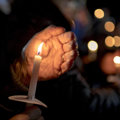 Community members participate in a vigil for the victims of Oxford High School shooting